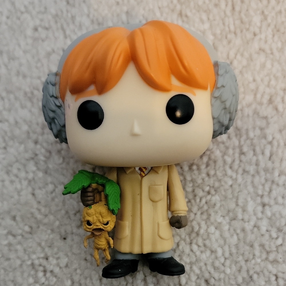 Funko Action Figure with Orange Hair and Green Plant